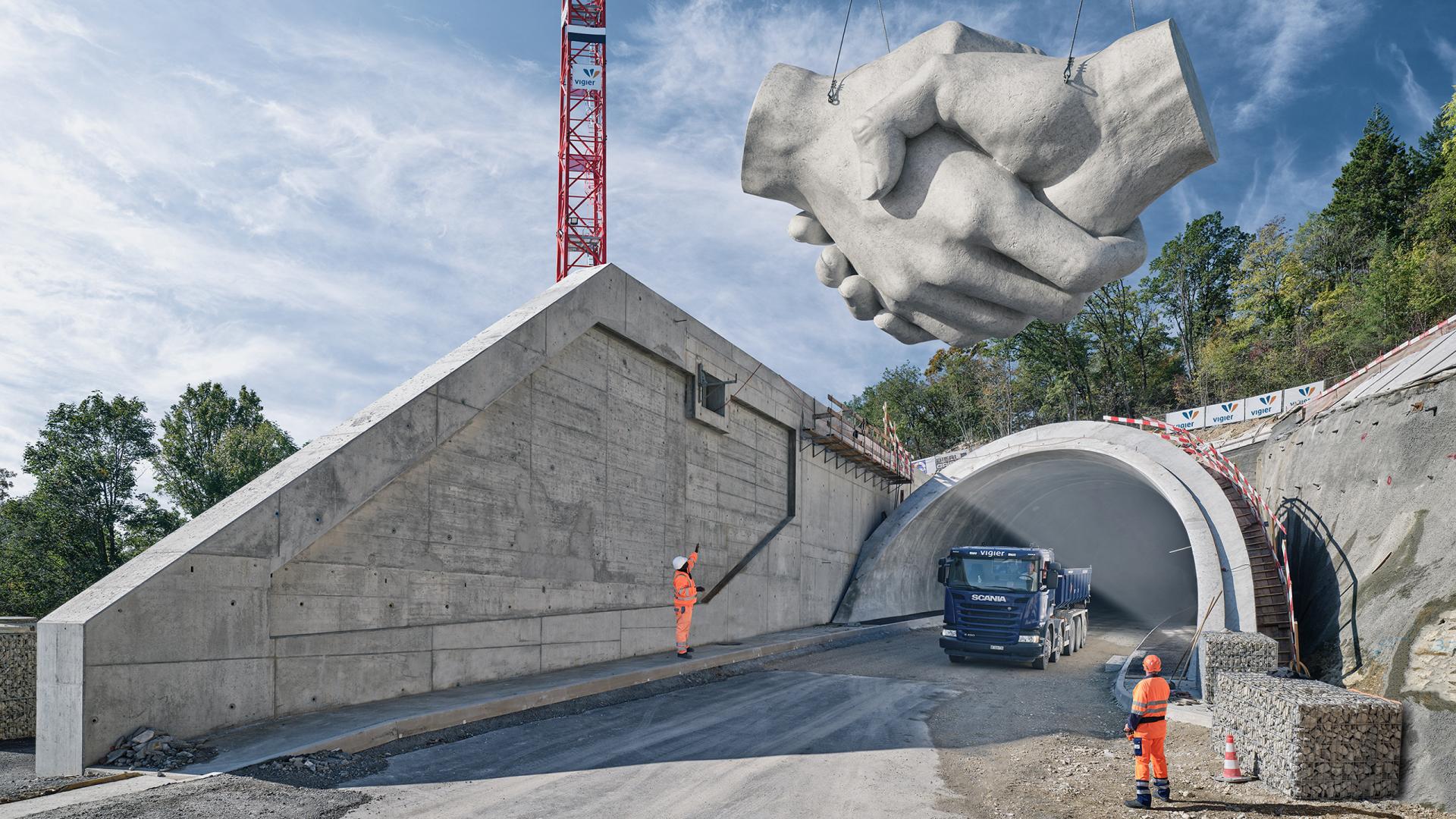 Tunnelbau mit Kran und Lastwagen. Objekt oben: Beton-Handshake